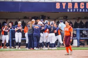 Syracuse crowds second baseman Alicia Hansen after her walk-off single on Saturday afternoon.