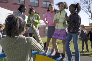 Students from Syracuse’ s Fowler High School and Westside Academy pose at the Movement on Main reveal on Wednesday. The new playground was featured of Otisco Street.  The prototype featured colorful rubber mounds, balancing boards and roundabouts.