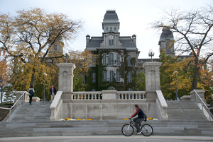 Community members at Syracuse University  can participate in political activities but need to specify that they aren't representing the university as a whole.