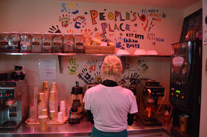 Abby Horton, an employee at People's Place, helped prepare the cafe for their grand reopening celebration on Friday afternoon by brewing fresh pots of hot coffee.