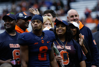 Darius Kelly looks out at the stands with his family during the Senior Day celebration 