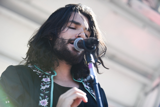 Stephen sports a black kimono on stage while performing.