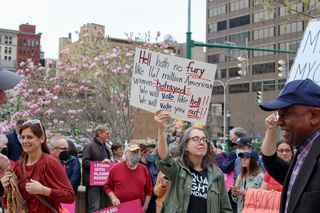 Signs with messages such as “Hell hath no fury like 167 million American women betrayed”  lined the streets of Clinton Square Tuesday evening. 